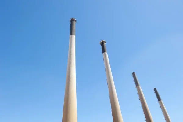 Isolated chimneys of power station plant — Stock Photo, Image