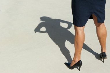 Sexy legs of confident woman as shadow