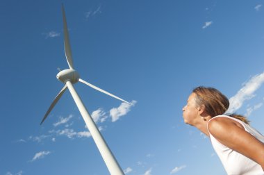 Renewable energy power wind mill and pushing woman clipart