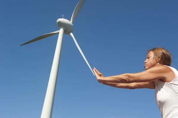 Renewable energy power wind mill and pushing woman — Stock Photo, Image