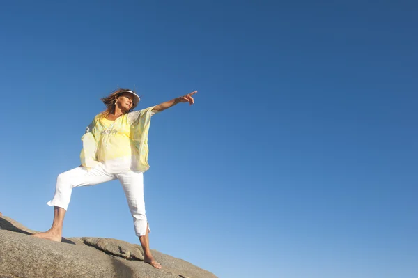 Confident sexy woman isolated on top of mountain rock — Stock Photo, Image