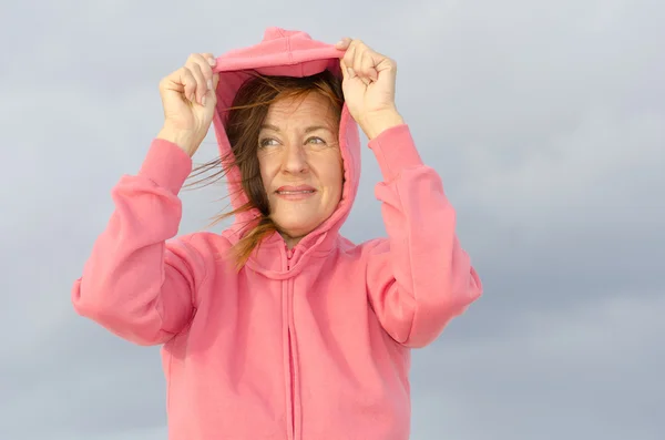 Mature woman relaxed at windy cold day at ocean — Stock Photo, Image