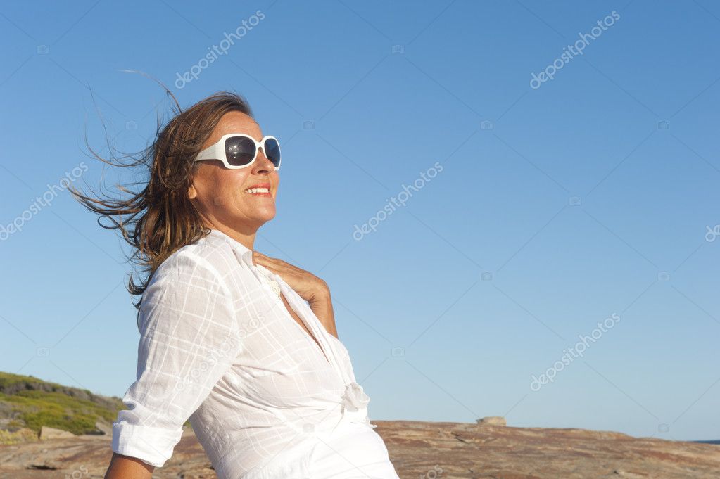 Sexy mature woman fancy dressed at beach Stock Photo by ©roboriginal 11113095