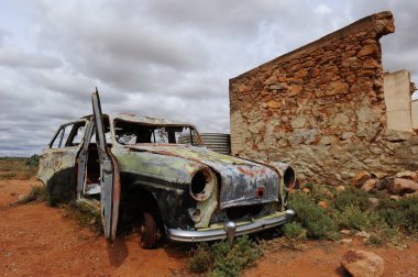 Ruin and car wreck in ghost town Australia clipart