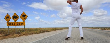 Woman on outback highway in Australian clipart