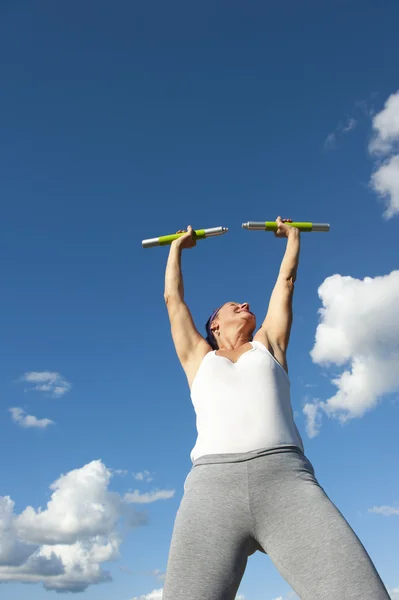 stock image Mature woman exercising with weights