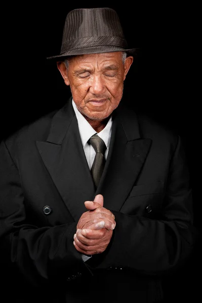 Senior man bidden — Stockfoto