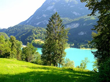 Blue mountain lake in a deep mountain valley clipart