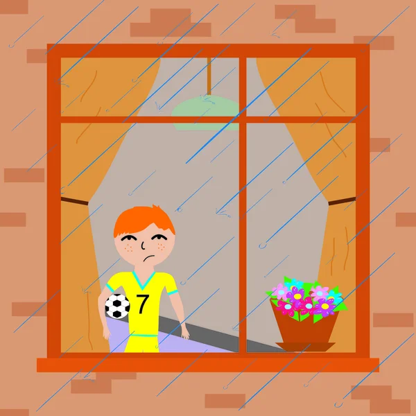 Мальчик у окна смотрит на дождь — стоковое фото