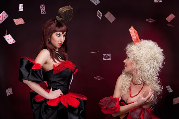 Two queens with cards on the black background — Stock Photo, Image