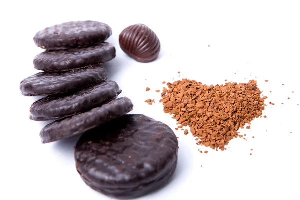 Instant coffee in the form of heart, a chocolate and cookies on — Stock Photo, Image