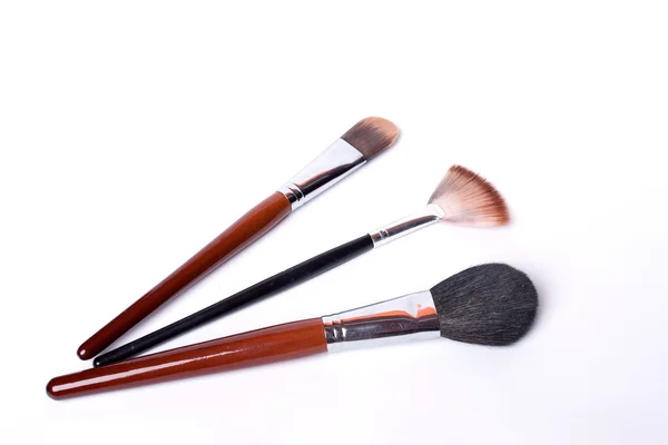 stock image The three brushes for a make-up on the white bacground