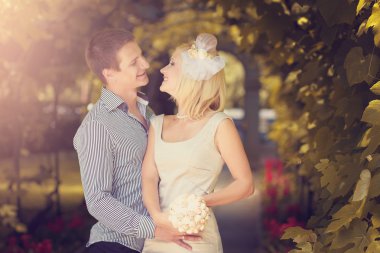 Wedding photo of the groom and the bride, looking against each o clipart