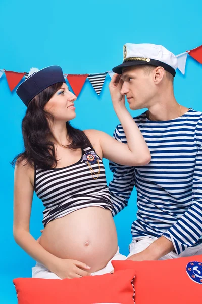 Couple in love during pregnancy in a marine style — Stock Photo, Image