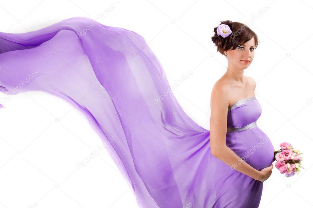 A pregnant woman in flying dress on a white background