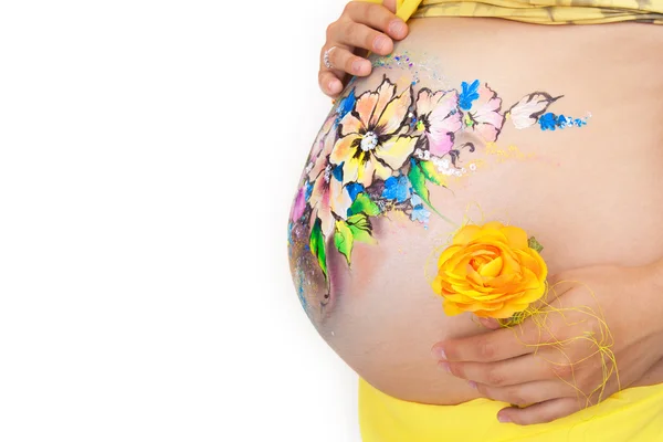 O abdômen de mulheres grávidas com flores pintadas — Fotografia de Stock