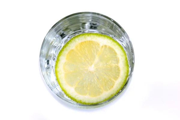 Drink in glass and lime slice , top view, on white background — Stock Photo, Image