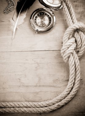 Ship ropes and compass in sepia clipart