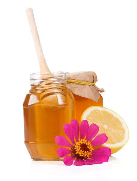 Tarro de vidrio lleno de miel y palo —  Fotos de Stock