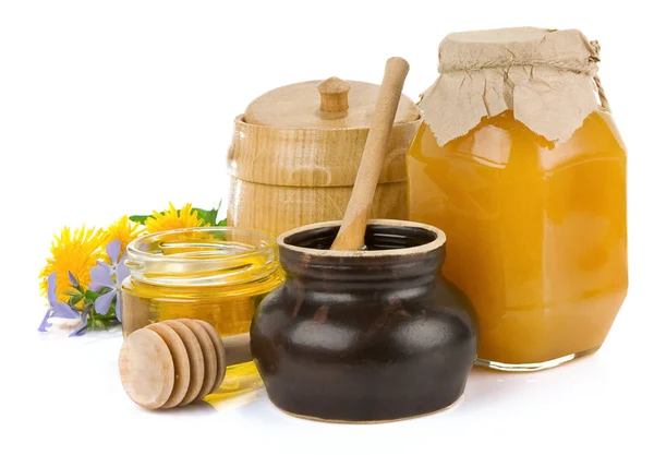 Jar of honey and flowers isolated on white — Stock Photo, Image
