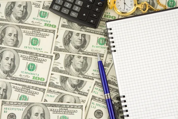 Ноутбук, ручка и часы в долларах — стоковое фото