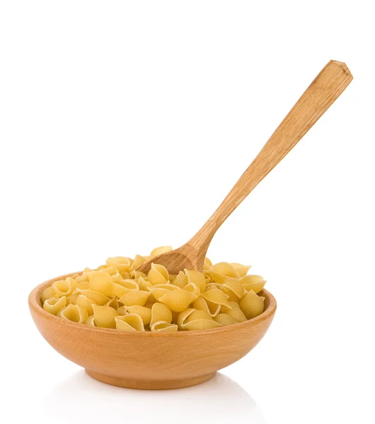 Raw pasta and wooden spoon — Stock Photo, Image
