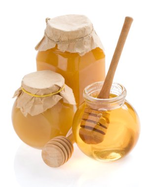 Glass jar full of honey and stick clipart