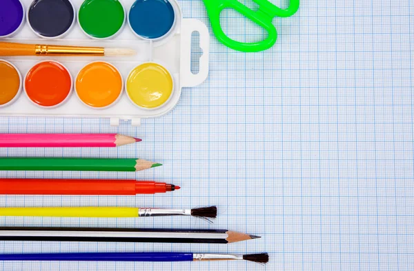 Pencils, felt pens, paint brush and scissors on paper — Stock Photo, Image