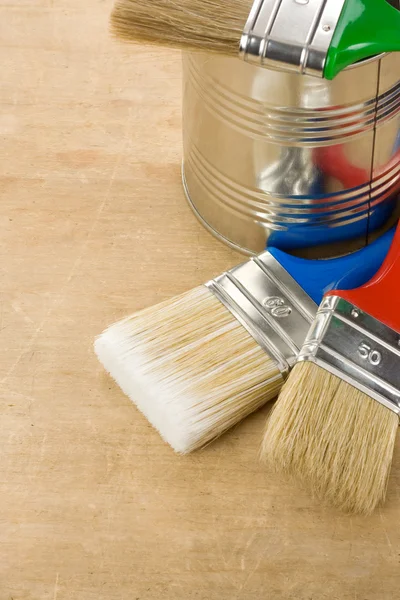 Paintbrush and can on wood — Stock Photo, Image