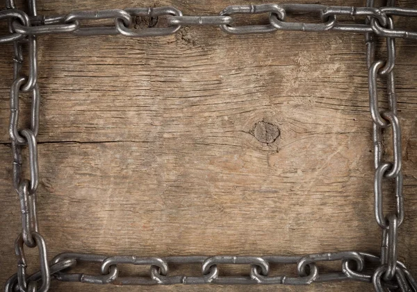 Metal chain on old wood — Stock Photo, Image