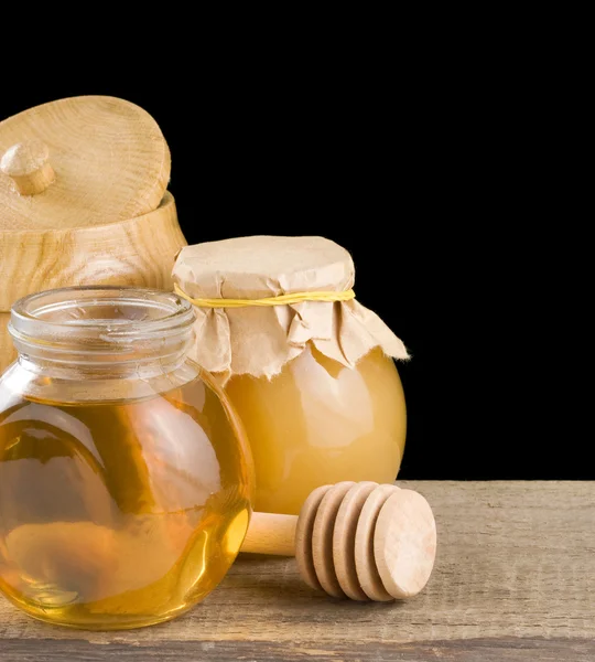 Tarro lleno de miel y palo — Foto de Stock