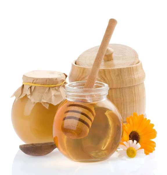 Glas mit Honig und Blumen — Stockfoto