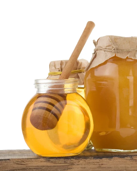 Jar of honey and stick on white — Stock Photo, Image