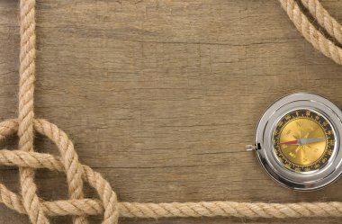 Ship ropes and compass with pen on old vintage wooden clipart