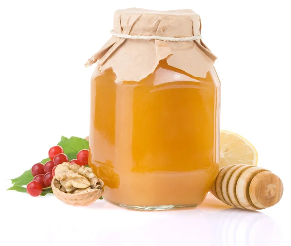 Vaso di vetro pieno di miele e frutta — Foto Stock