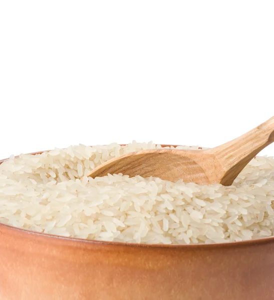 Uncooked rice in plate and spoon — Stock Photo, Image