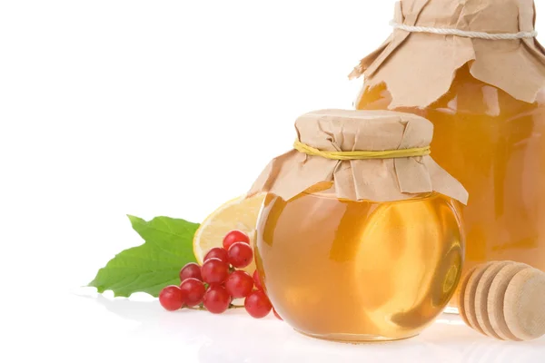 Glass jar full of honey on white — Stock Photo, Image