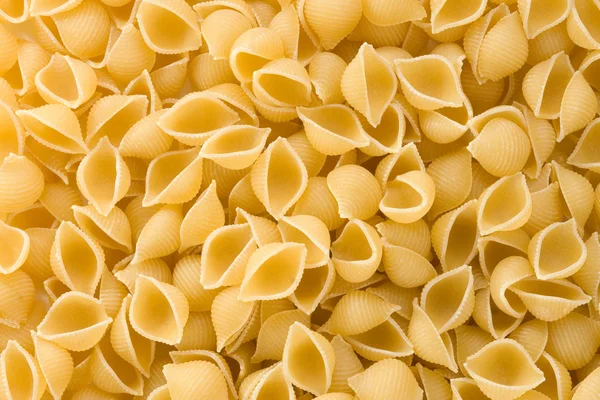 Rå pasta som bakgrund — Stockfoto