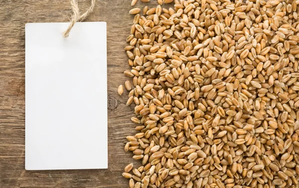 Wheat grain on wood texture — Stock Photo, Image