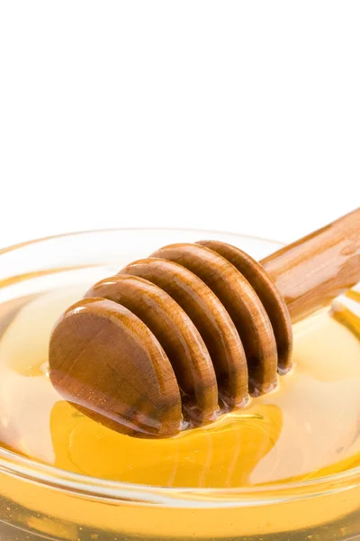 Miele in vetro e bastone isolato su bianco — Foto Stock