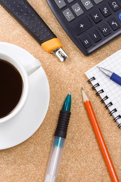 Kontrolleras anteckningsboken och kopp kaffe i office — Stockfoto