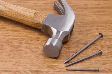 Hammer and nail on wood clipart