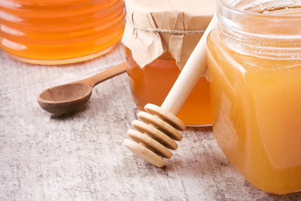 Glass pot full of honey — Stock Photo, Image