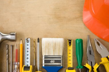 Set of construction tools on wood background clipart