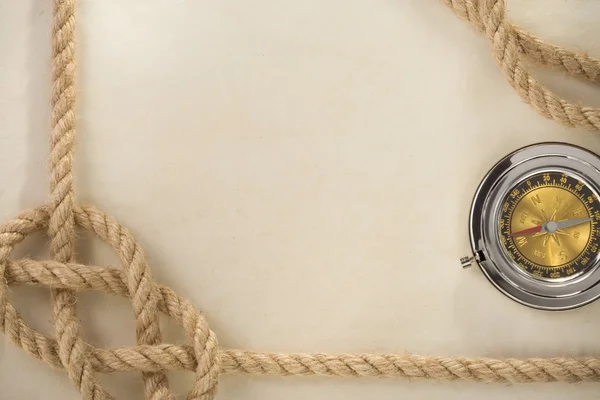 Ropes and compass on old vintage ancient paper background — Stock Photo, Image