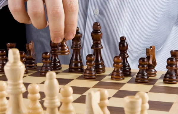Male hand moving chess piece — Stock Photo, Image