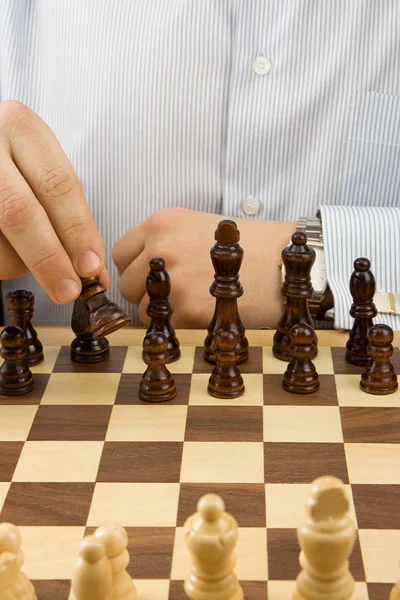 Hand moving chess black piece — Stock Photo, Image