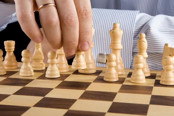 Hand moving chess piece — Stock Photo, Image