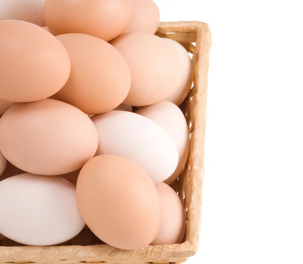 Αυγά σε ψάθινο καλάθι που απομονώνονται σε λευκό — Φωτογραφία Αρχείου