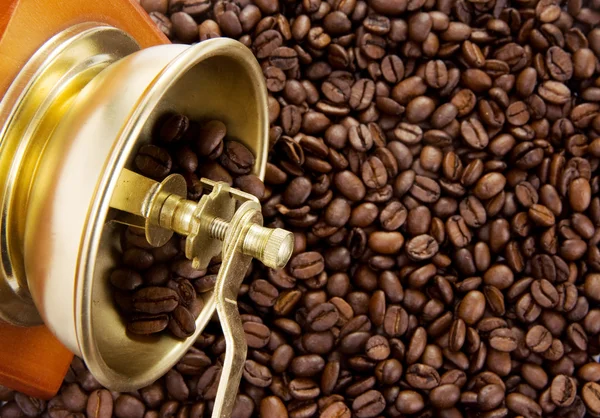 Grinder on roasted coffee beans — Stock Photo, Image